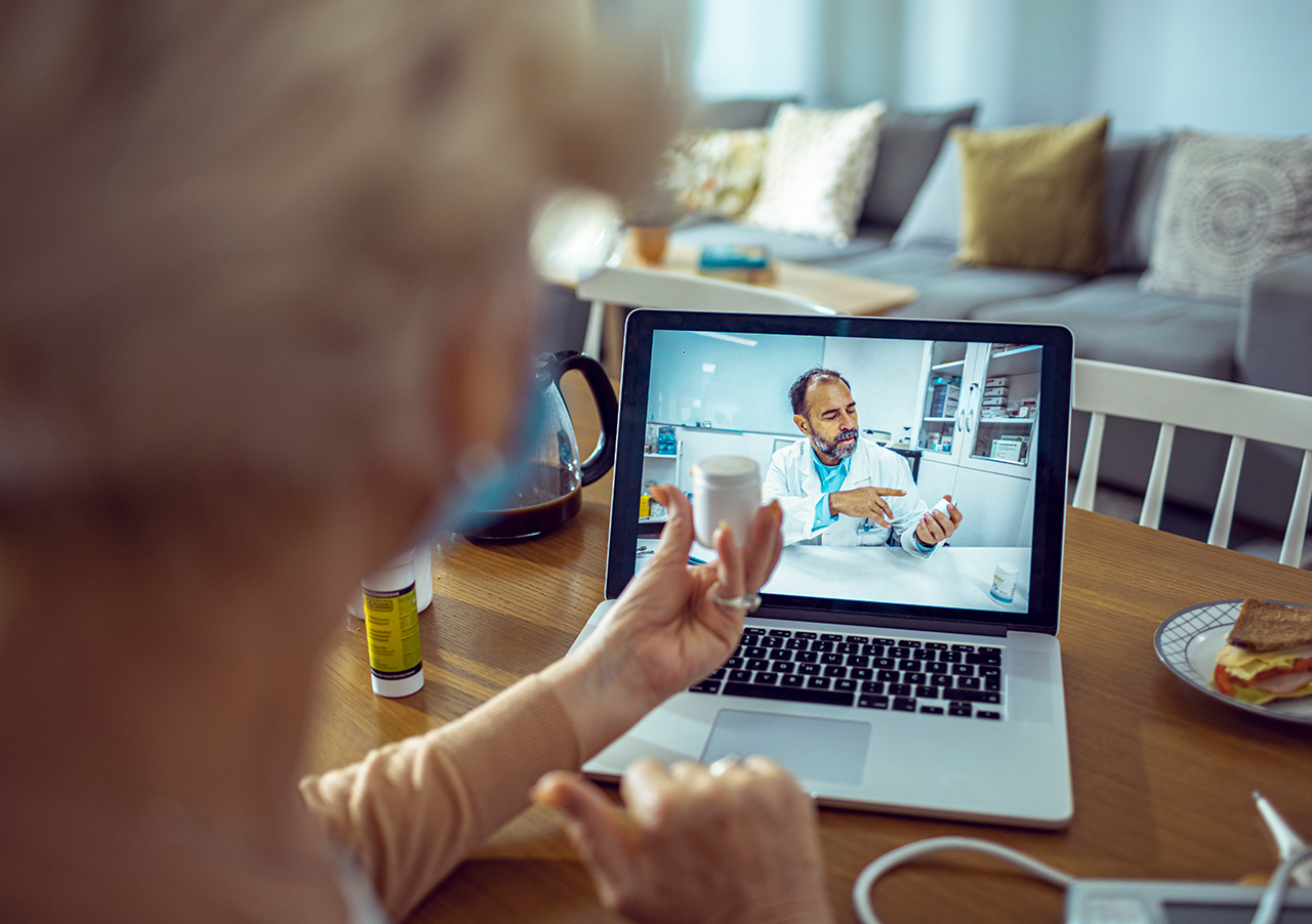 Senior patient shares remote patient monitoring information with doctor on telehealth meeting