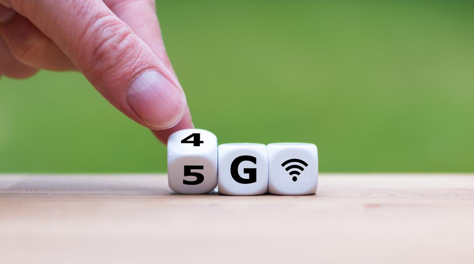 Up-close shot of a hand turning dice to read 5G wireless