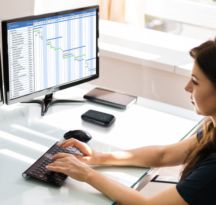 Woman in home office working on project management software while connected to the TD0301 modem