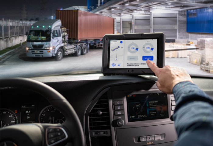 Truck driver using JACS Solutions TT800V tablet to log driving route data.
