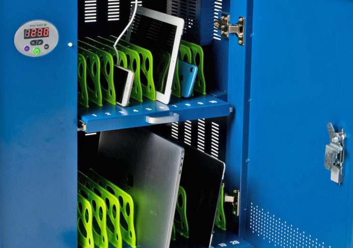 Laptops, tablets and mobile phones stored inside of JACS solutions charging cart.