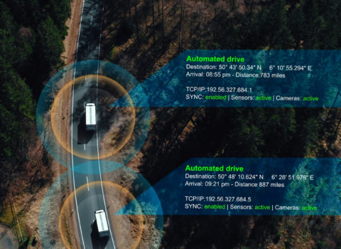 JACS Solutions drone aerial view of two trucks driving with data tracking graphic overlay.