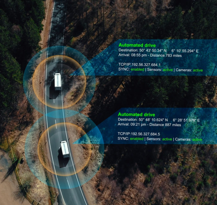 JACS Solutions drone aerial view of two trucks driving with data tracking graphic overlay.