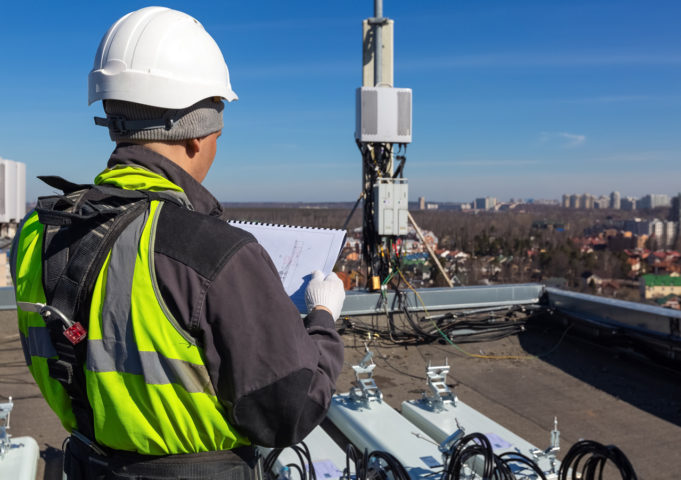 Man working on rooftop custom private LTE antenna installation