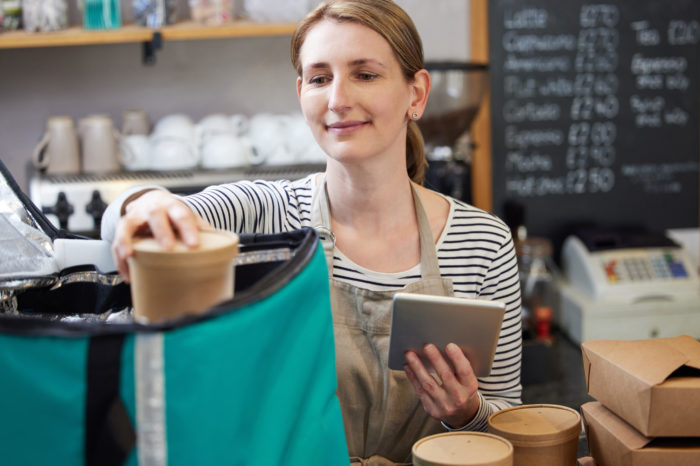 Store clerk packing an order of ice cream for delivery