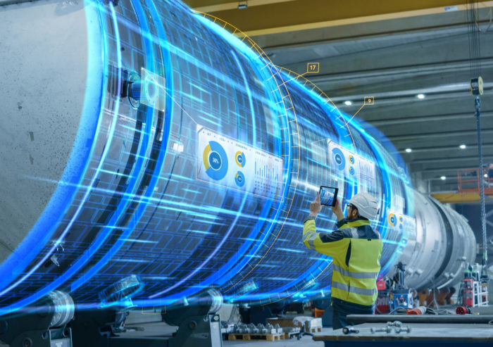 Engineer using augmented reality to scan a rocket engine in a facility using connectivity solutions